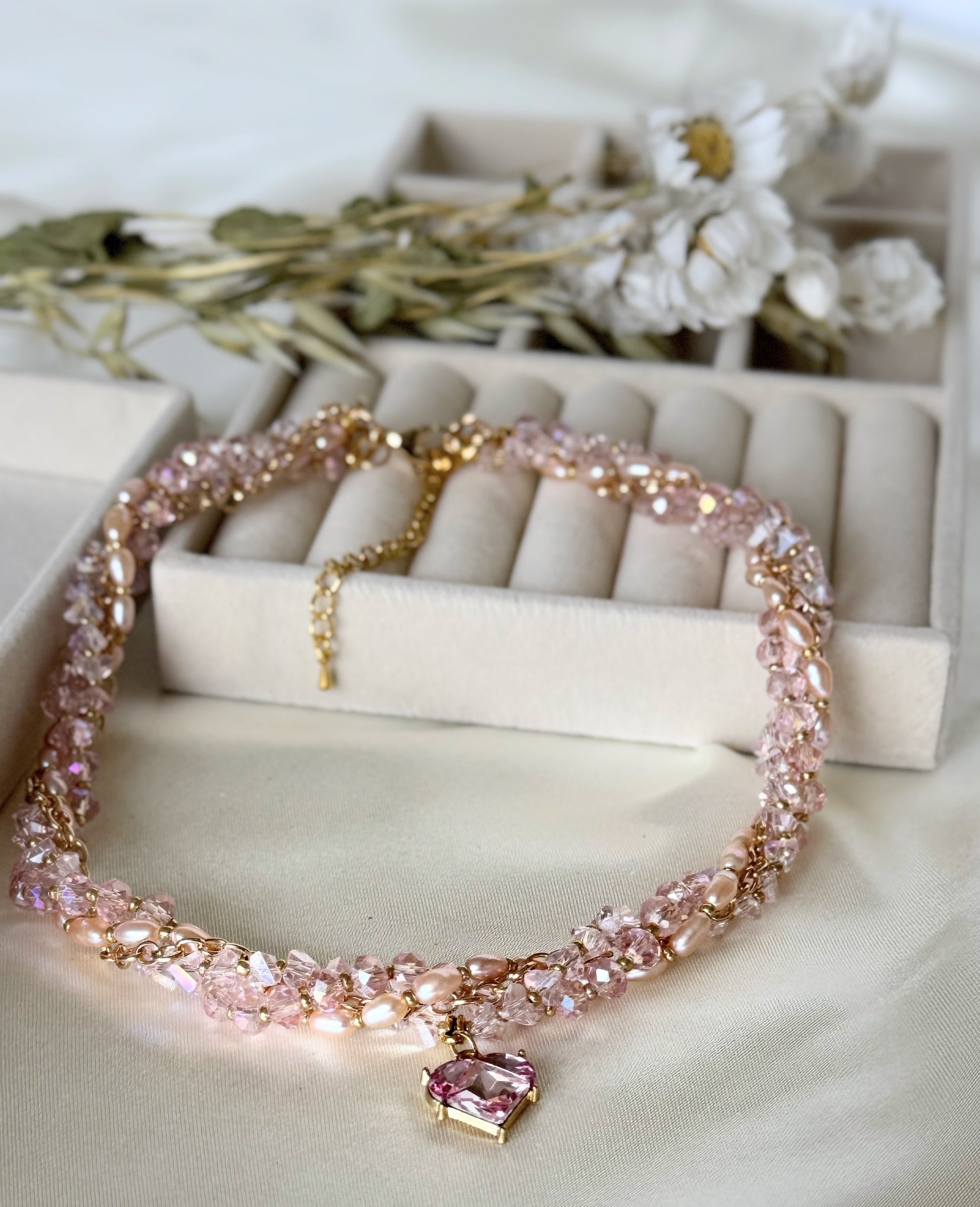 Detail shot of freshwater pearls on pink layered necklace